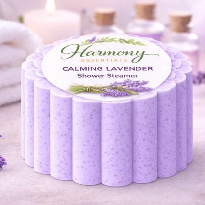 Lavender shower steamer with 'Harmony Essentials' label on a light background with lavender flowers and towels.